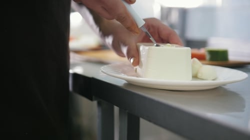 Chef Cut the Cheese Feta for Salad in Commercial Kitchen