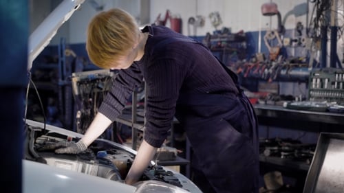 Professional Mechanic Checks the Operation of the Engine with a Stationary Computer