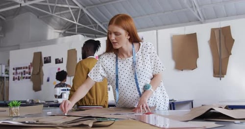Caucasian woman working in fashion office