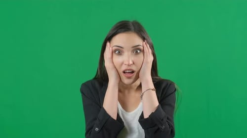 Portrait of Amazed Young Woman Over Green Screen Background for Keying. Shocked Woman with Mouth