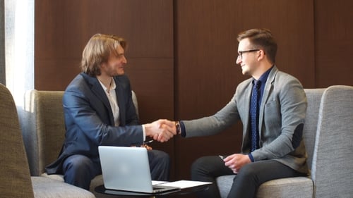 Two Young Men Shake Hands After Business Meeting