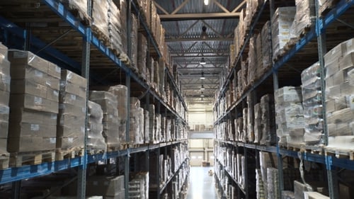 Camera Moves Up on Shelves of Cardboard Boxes Inside a Storage Warehouse