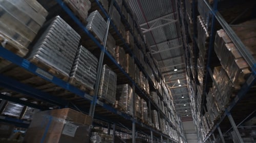Warehouse Interior With Pallets and Boxes on Shelves