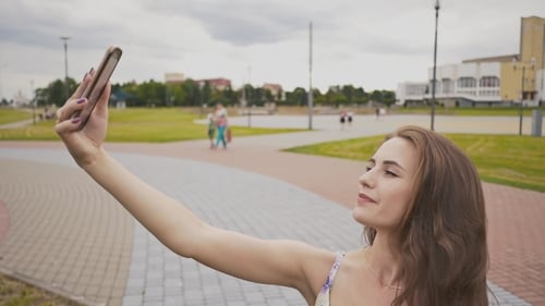 Woman Taking Selfie on Mobile Phone in Park