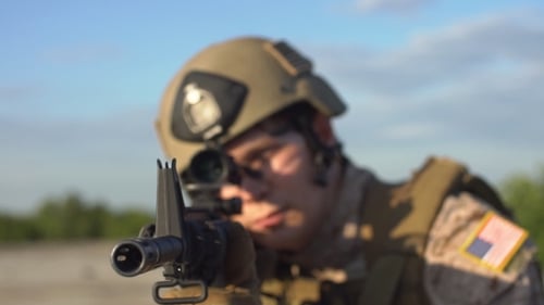 Soldier Aims Rifle Towards Camera
