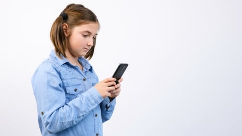 Cute Child Using Smartphone Against White Background