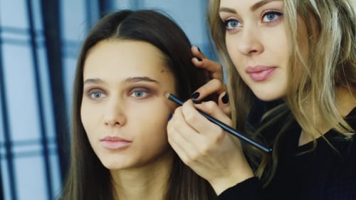 Makeup Artist Applying Eyeshadow on Model