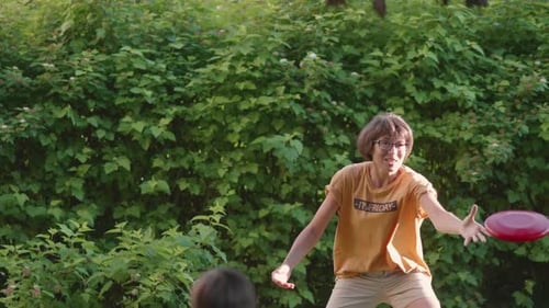 Woman and Child Play Disc Golf in Yard