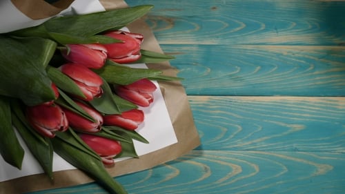 Red Tulips and Love Card on Blue Wood