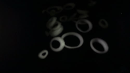 Onion Rings Slices Fall on Black Background