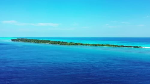 Wide angle above clean view of a paradise sunny white sand beach and blue sea background in vibrant