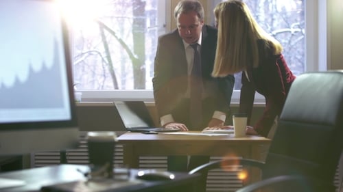 Colleagues Man and Woman Emotionally Discussing Business Plans in an Office
