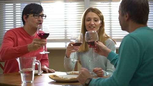 Three Friends Drinking Red Wine in the Restaurant