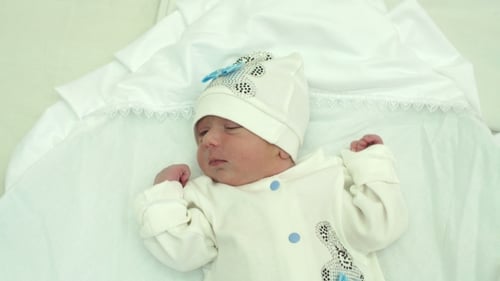 Adorable Newborn Infant Lying on White Blanket