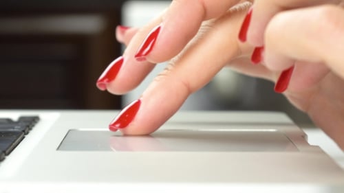 Fingers Using Laptop Trackpad with Red Nails