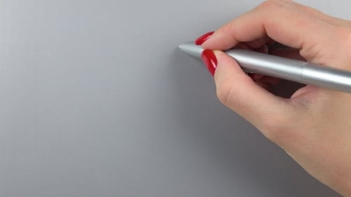 Woman's Right Hand with Red Manicure Using Pen Tablet. Top View.
