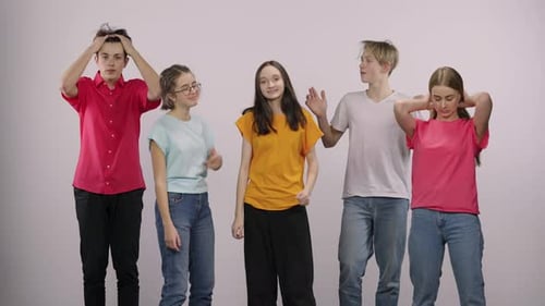 Group of Teens Dancing in Front of White Background