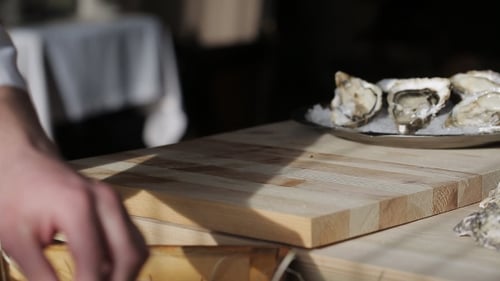 The Chef at the Restaurant Opens Oysters