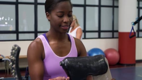 Physical Therapist Assists Man with Prosthetic Leg