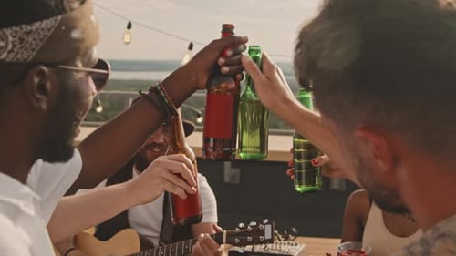 Friends Toasting and Enjoying Music on Rooftop Terrace