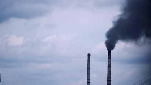 Smoke from industrial chimney. Factory with main chimneys expelling smoke into sky