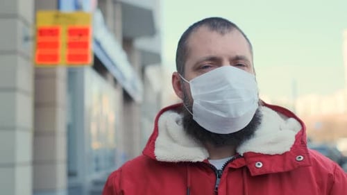 Portrait of a Man with Protective Face Mask on Currency Exchange Background. Pandemic Disease Virus