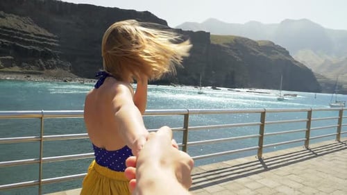 Woman Leads the Way on Tropical Pier