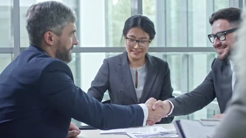 Business Professionals Signing Contract at Workplace Meeting