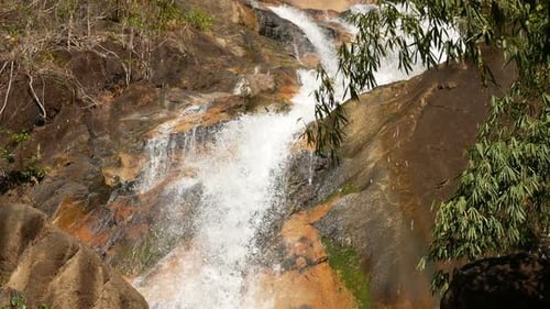 Tropical Waterfall Cascading Through Lush Green Forest