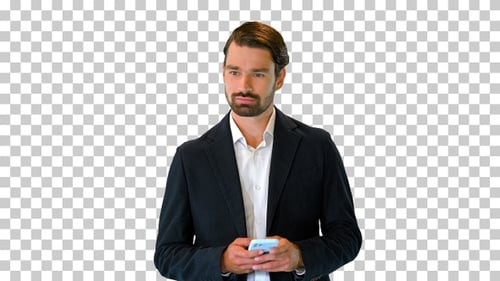 Young businessman walking and texting on his phone, Alpha Channel