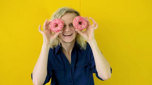 Woman Posing with Colorful Pink Donuts
