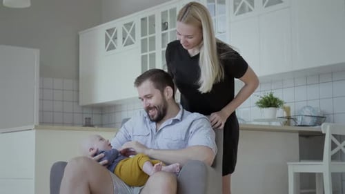 Young and happy parents with their adorable infant