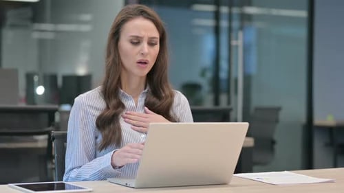 Woman Coughing While Using Laptop in Office