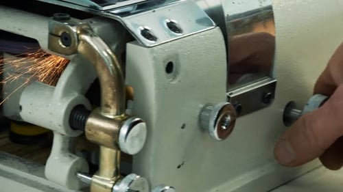 Craftsman Sharpening a Blade on a Skiving Machine. The Grinding Wheel on Skiving Machine