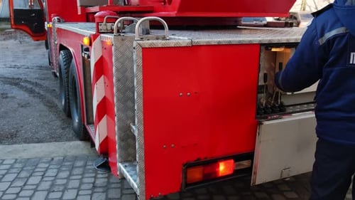 Close Up the Firefighter's Hands Control the Ladder of the Fire Truck V3