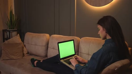 Focused Woman Typing on Laptop Green Screen Chromakey Browsing Internet Study or Work Sitting on