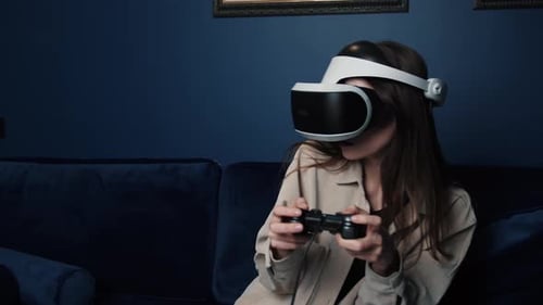 Woman Playing Video Games Exciting Emotion on the Sofa at Home, Using Joystick Controller