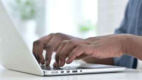 Close Up Young African Man Hand Typing on Keyboard
