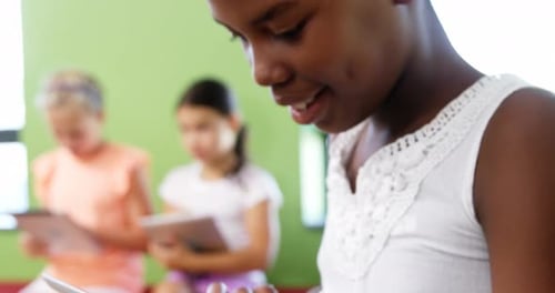 Schoolgirl using digital tablet