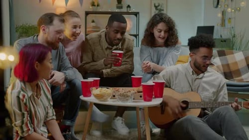 Friends Enjoying Music and Snacks at Party