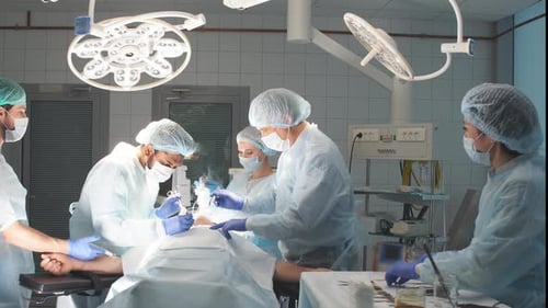 Team of Professional Surgeons Working at Hospital Performing Surgical Procedure.