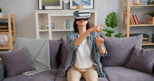 Woman Using VR Headset on Couch