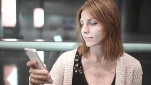 Young Adult Using Smartphone Indoors Close Up