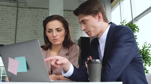 Young Professionals Working Together on Laptop