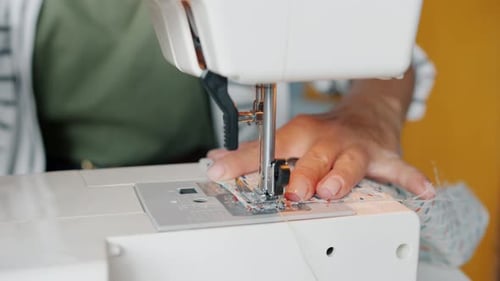 Close Up Woman Sewing Fabric on Machine