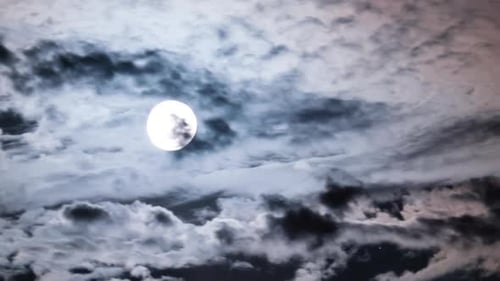 Full Moon Moves in the Night Sky Through Dark Clouds Timelapse