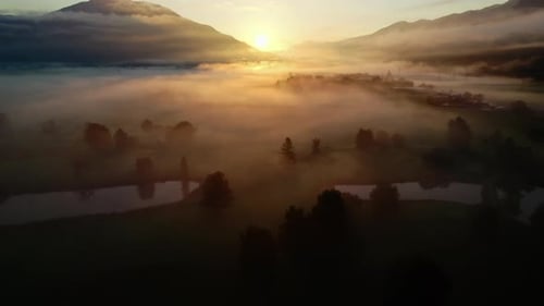 Breathtaking Sunrise over Misty Rural Landscape