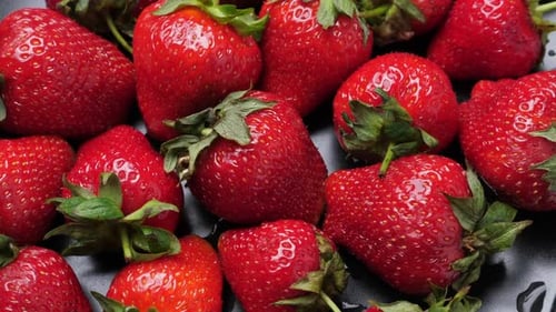 A Lot of Red and Ripe Strawberries Rotating