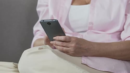 Senior Woman Using Gray Mobile Phone