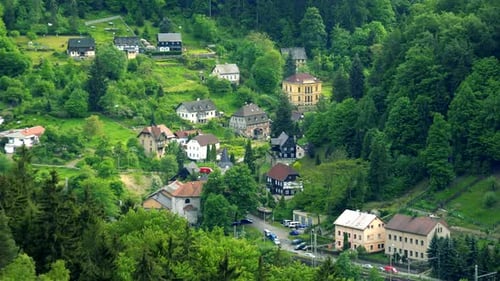A Village Enclosed with a Forest and Rocks - Top View